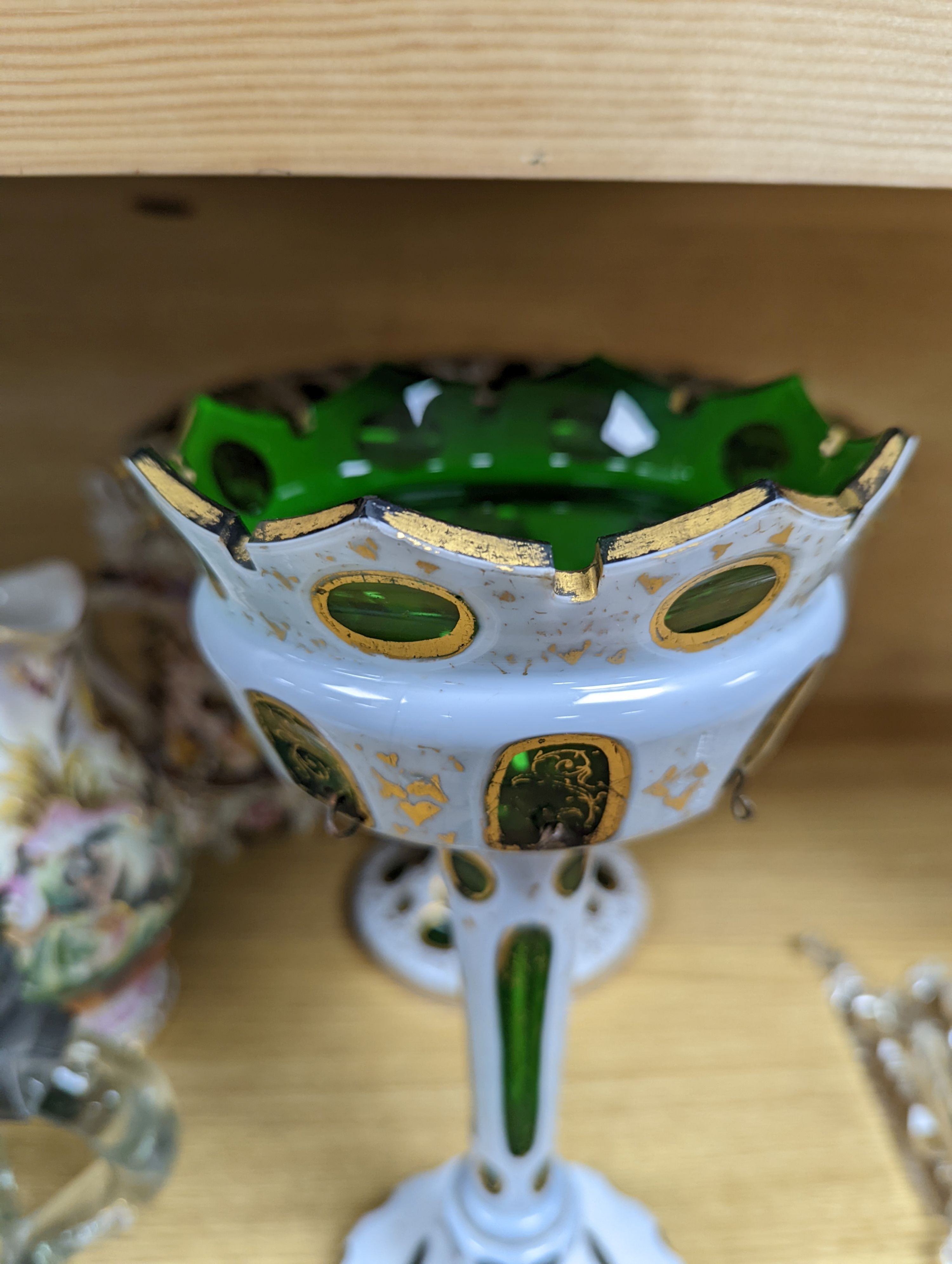 A 19th century overlaid green glass comport, 24cm high, and a similar table lustre